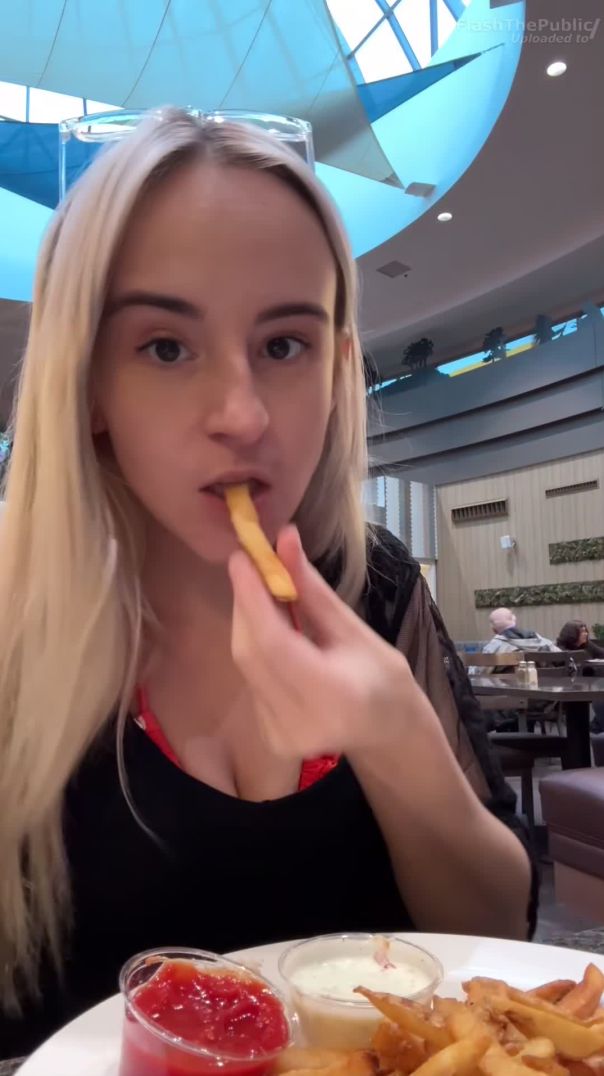 Beautiful girl showing boobs in restaurant